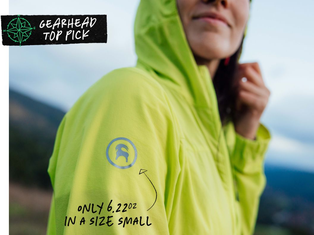 A woman wears a bright yellow-green jacket. Text overlay reads: Gearhead top pick, only 6.22oz in a size small.